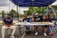 Volunteers from Capital Youth Empowerment Program pose and smile for the camera