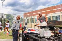 Alexandria Police and man posing by the grill