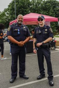 Two Alexandria policemen are standing and posing for the camera
