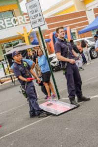 Two Alexandria Fire Department firemen are playing cornhole