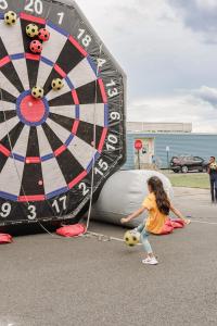 Girl in muted orange kicks a soccer ball