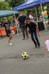 Preteen boy is getting ready to kick a yellow soccer ball