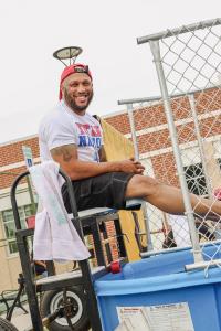 Man sitting on a dunk tank