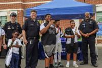 Kids and Alexandria Police smiling for the camera