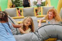 Three girls playing on a bounce house