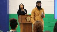 two graduated students speaking with inmates
