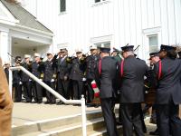 Alexandria Fire Department leadership salutes as the honor guard moves Deputy Chief Hricik into Vienna Presbyterian Church for his memorial service on Saturday, March 11, 2023. 