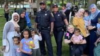 three deputies and several women and children at neigborhood event