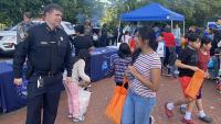 sheriff speaking with young woman at community event