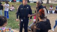 sheriff and community leader jim paige with residents at outdoor neighborhood event