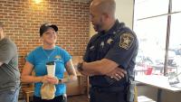 community member speaking with deputy inside coffee shop