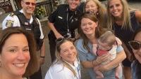 selfie of a group of uniformed law enforcement officers, civilian employees and community members