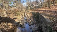  Image of existing stream and retaining wall conditions at the Oakland Terrance-Timber Branch Project site.