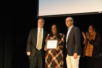 nechelle smiling with award, city manager, and mayor