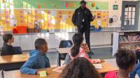 Deputy speaking to a class of elementary students