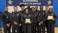 Nine deputies standing with Sheriff at awards ceremony