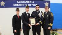 Two military retirees, deputy and sheriff with deputy holding an award plaque