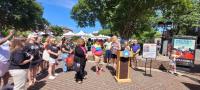 crowd around podium during crosswalk dedication