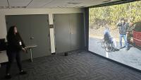 A civilian tries a law enforcement training firearms simulator