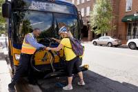 Person putting bike on DASH Bus