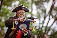 The town crier reading from a scroll