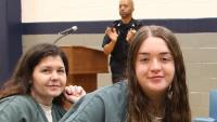 Two inmates smiling at a recognition program