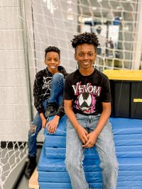 Two teen boys smiling at the camera