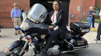 Community member sitting on a Sheriff's Office motorcycle