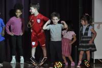 Kids dressed in casual clothes on stage