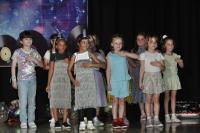 Group of kids on stage standing and posing