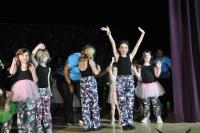 Kids smiling and waving at the crowd