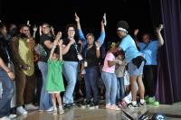 City staff and kids having fun and smiling while on stage