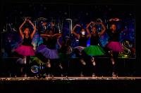 Performers in black with colorful tutus and doing a ballet pose