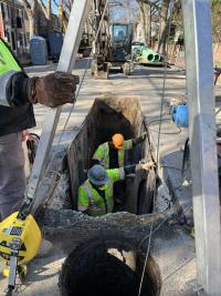 The contractors carefully dig a trench to remove the old pipe and place the new pipe into.  The new pipe connects to an existing manhole on S Royal St. 