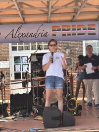 Speaker on stage at Alexandria Pride 2025