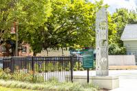 Colasanto park public art with black fencing next to it