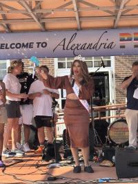 Speaker on stage at Alexandria Pride 2025