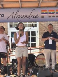 Speaker on stage at Alexandria Pride 2026