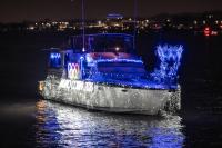 picture of boat on the water with holiday lights 