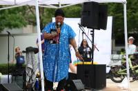 Person speaking on stage at Alexandria Pride 2026