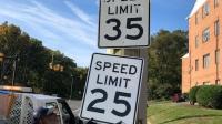 A photo showing a new 25 MPH speed limit sign being installed
