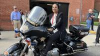 Community member sitting on a Sheriff's Office motorcycle