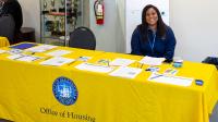 woman smiling at camera behind table