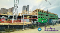 housing construction photo with city of alexandria seal and bloomberg philanthropies logo in bottom right corner
