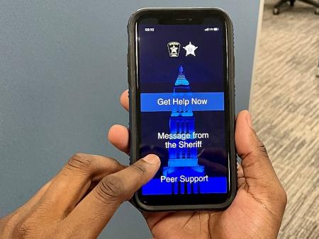 hands holding a mobile phone with a screen displaying employee wellness app