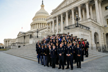 A group of Graduates from the Police Leadership Academy staning together in front of the US Capitol. 