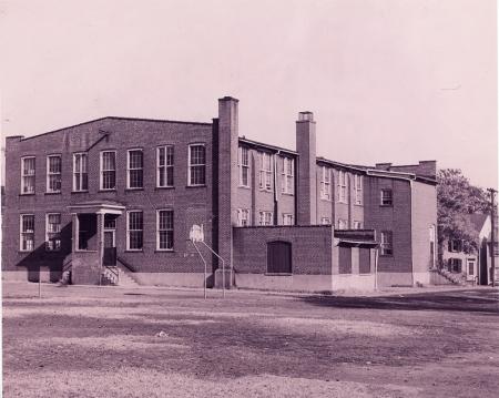 Old silk factory used as school, with basketball hoop