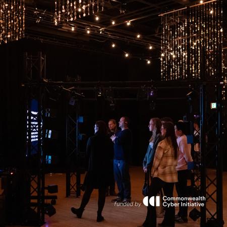 Image of a crowd of people walking under lights