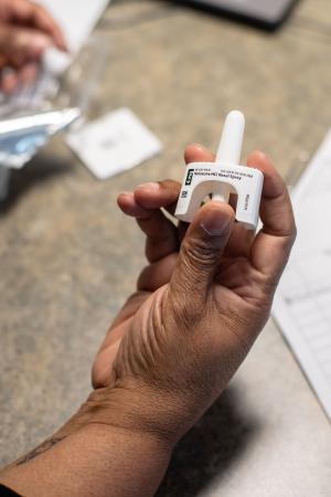 Hand holding Narcan