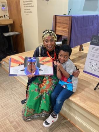 Woman holding a picture book, with child